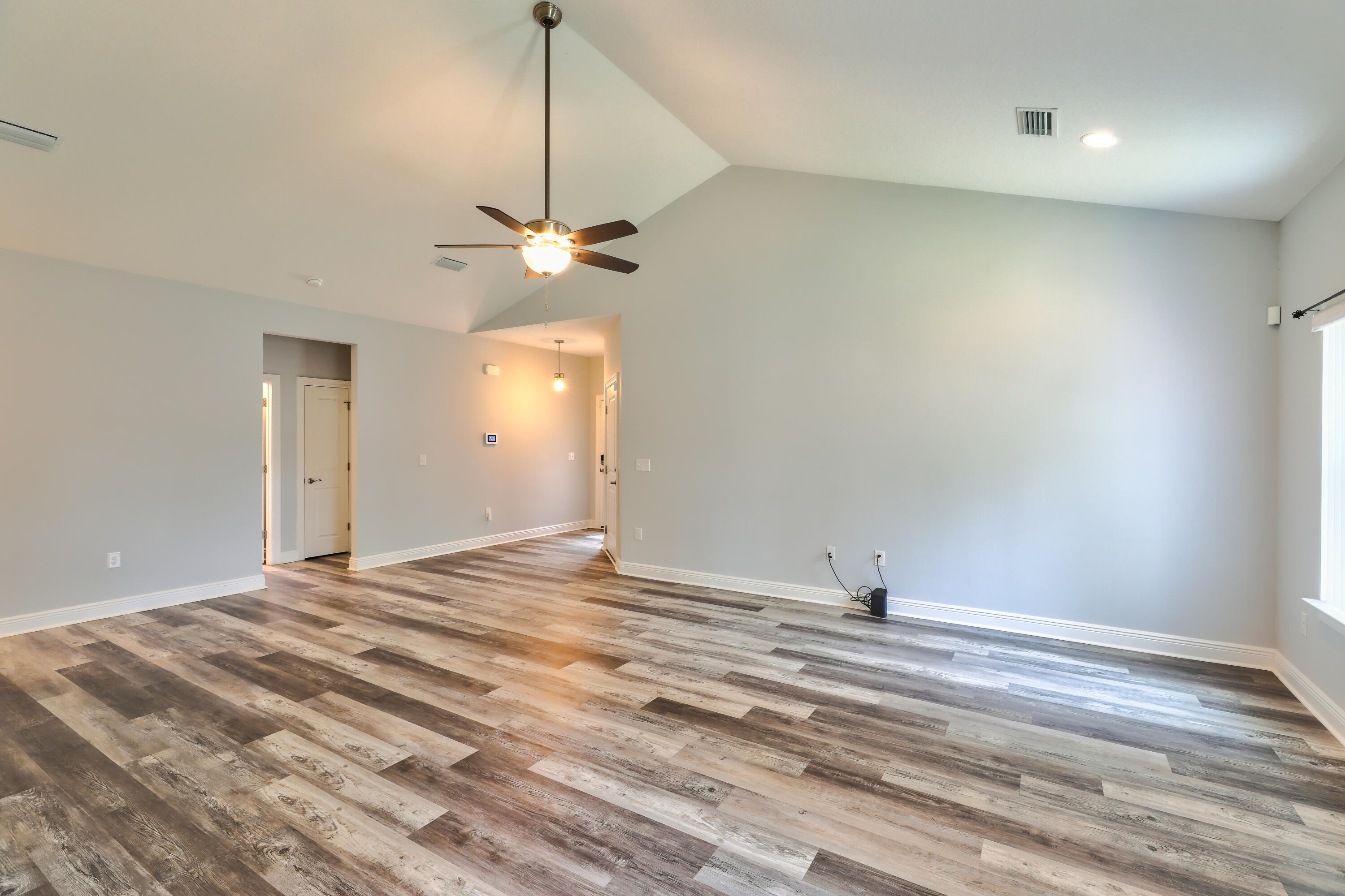 6160 Hayes Drive Crestview, FL 32539 - Photo 16 of 45 a view of a livingroom with a chandelier fan and a wooden floor