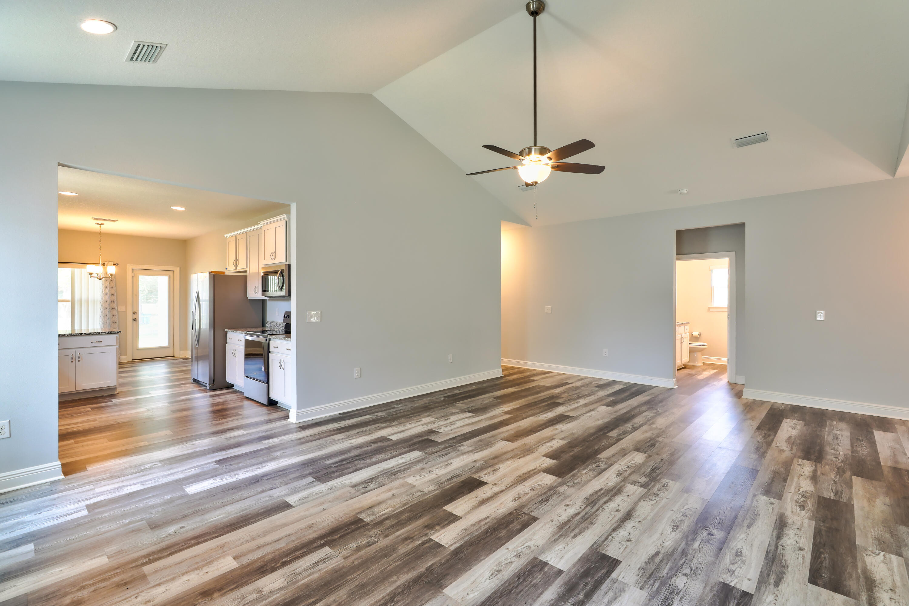 6160 Hayes Drive Crestview, FL 32539 - Photo 17 of 45 a view of empty room with wooden floor and fan