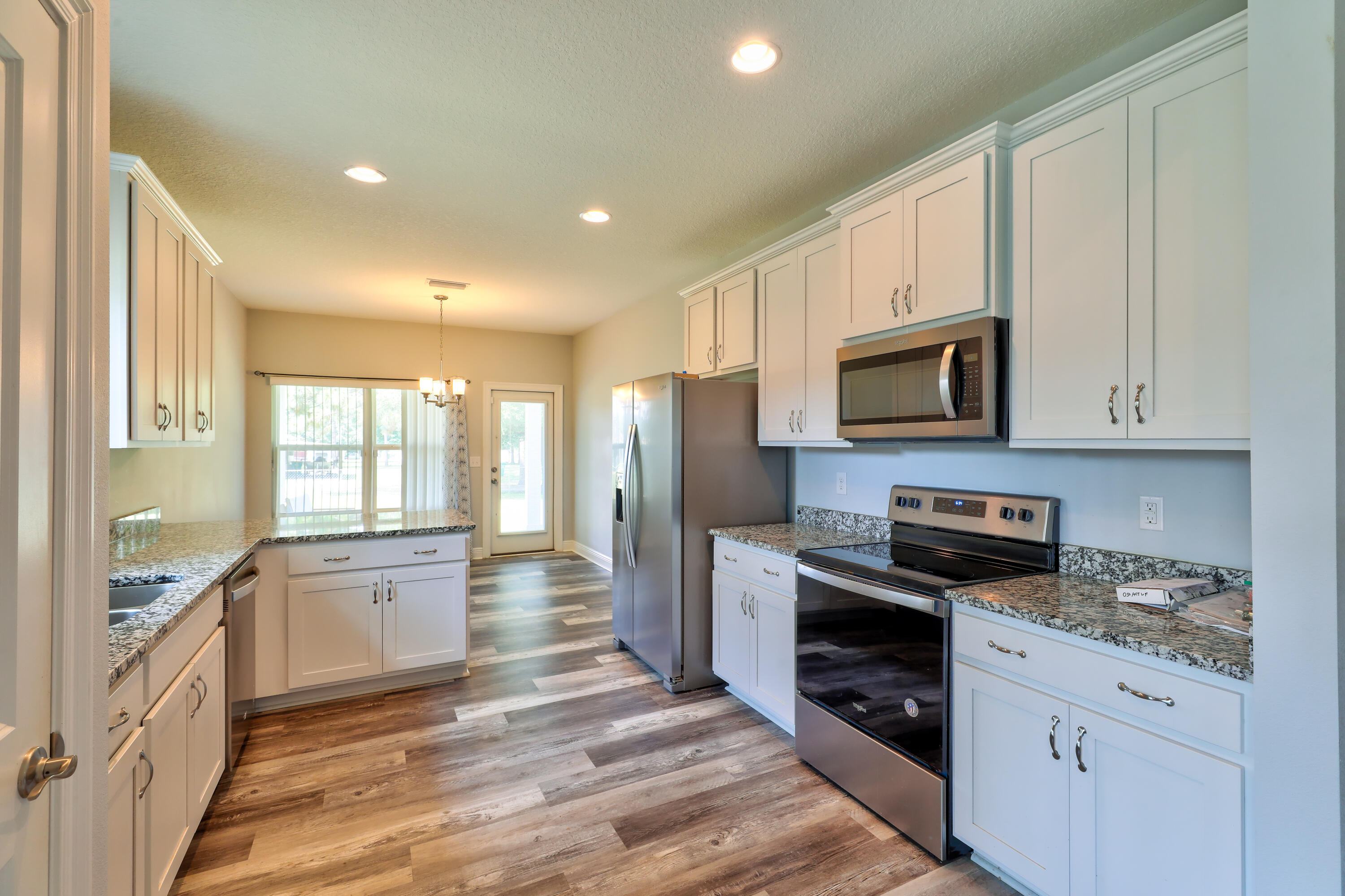 6160 Hayes Drive Crestview, FL 32539 - Photo 18 of 45 a kitchen with stainless steel appliances granite countertop a refrigerator a stove top oven a sink and dishwasher