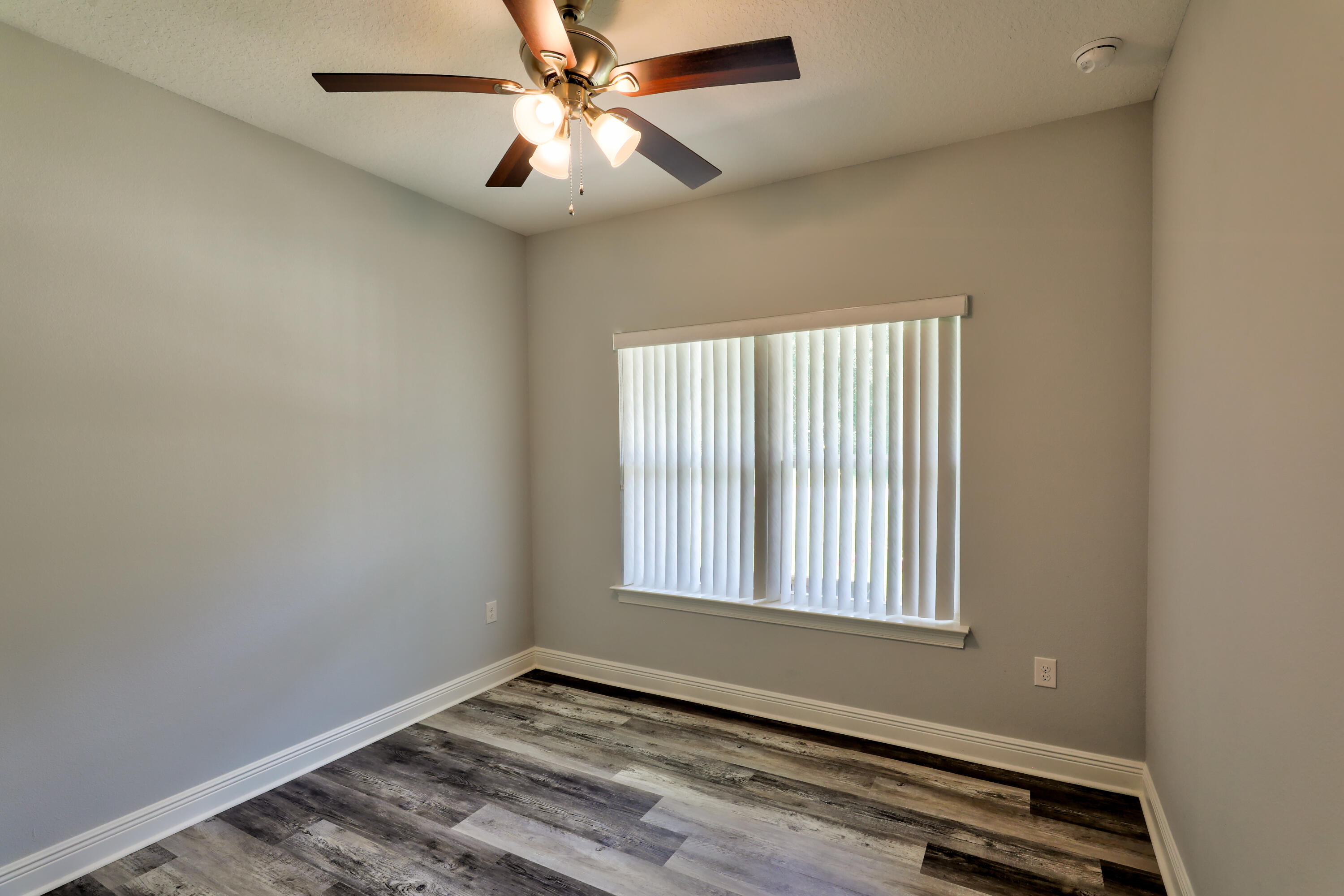 6160 Hayes Drive Crestview, FL 32539 - Photo 28 of 45 an empty room with windows and fan