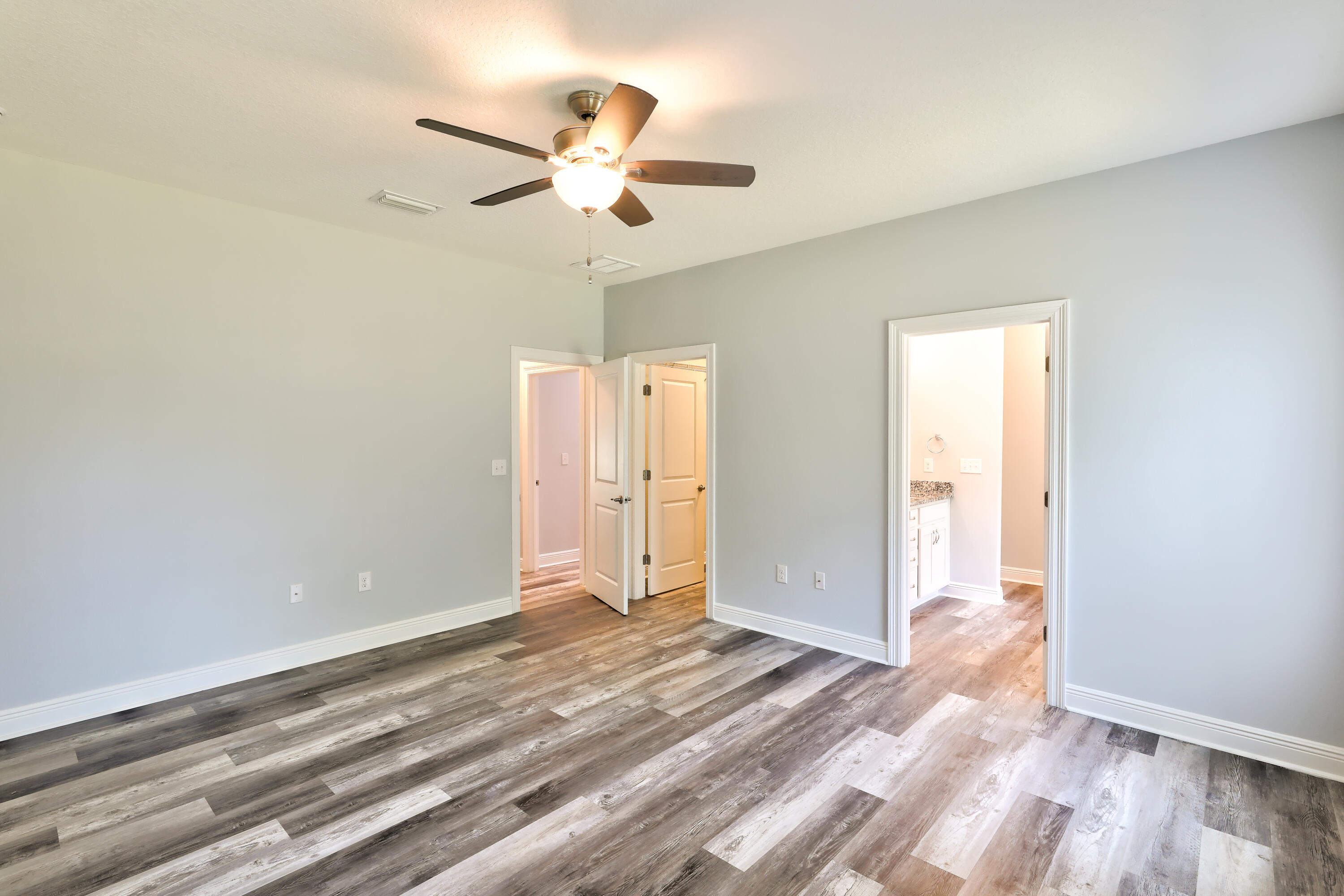 6160 Hayes Drive Crestview, FL 32539 - Photo 32 of 45 an empty room with wooden floor fan and windows