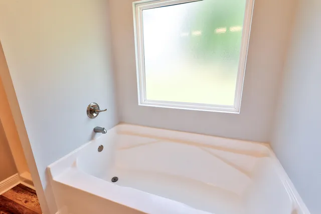 a view of a kitchen with stainless steel appliances granite countertop cabinets and a chandelier