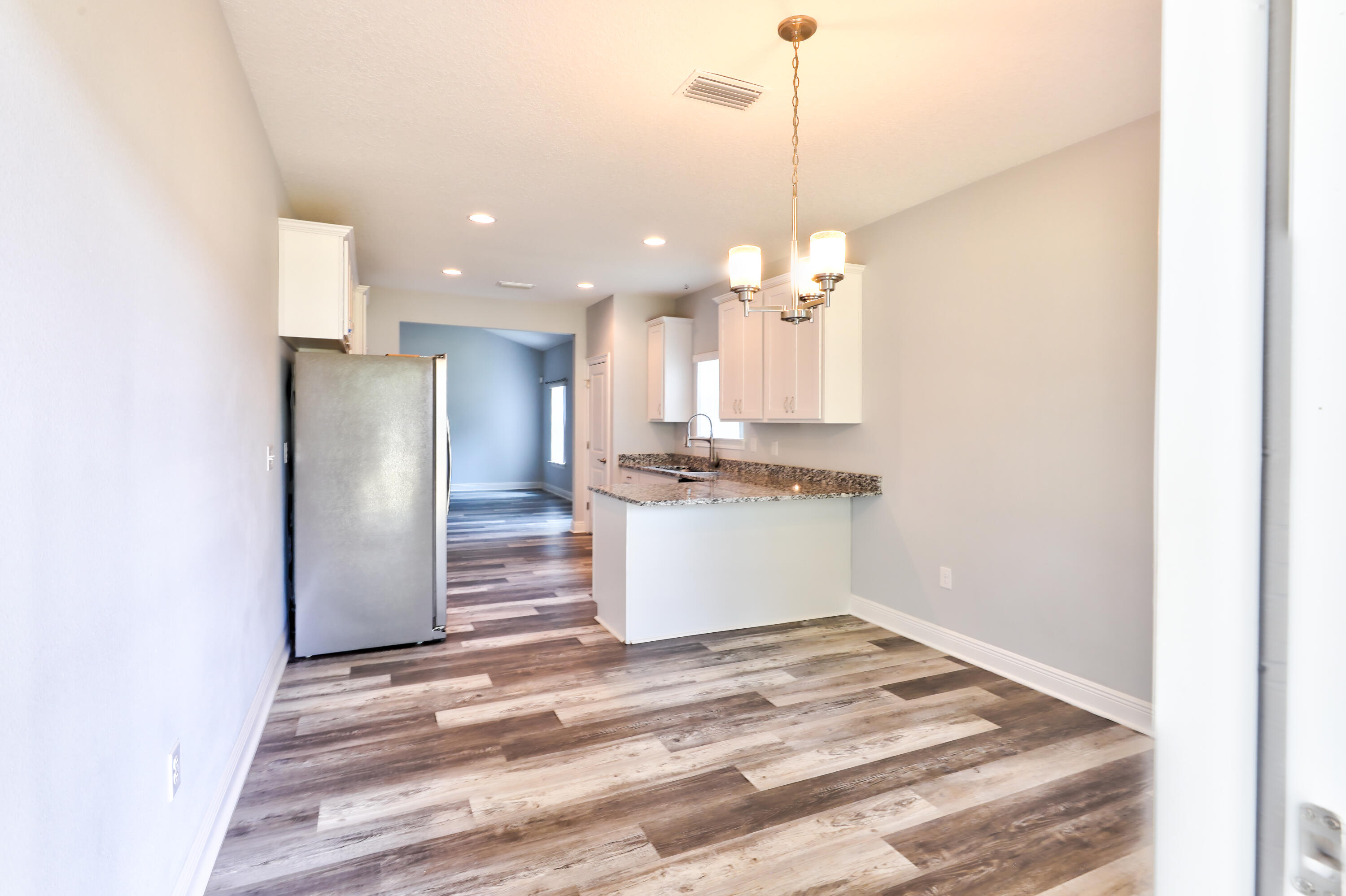 6160 Hayes Drive Crestview, FL 32539 - Photo 38 of 45 a view of a kitchen with stainless steel appliances granite countertop cabinets and a chandelier