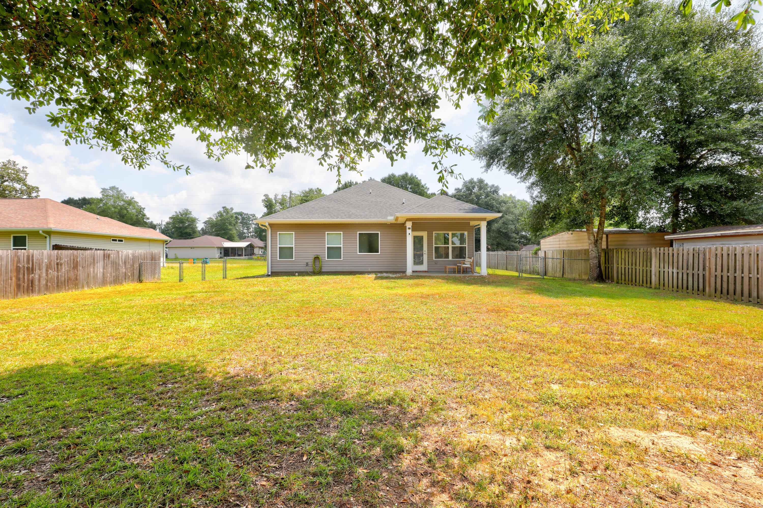 6160 Hayes Drive Crestview, FL 32539 - Photo 40 of 45 a house view with swimming pool in front of it
