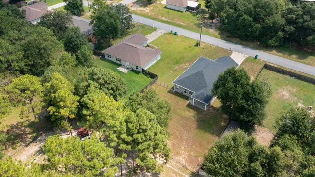an aerial view of house with yard swimming pool and outdoor seating