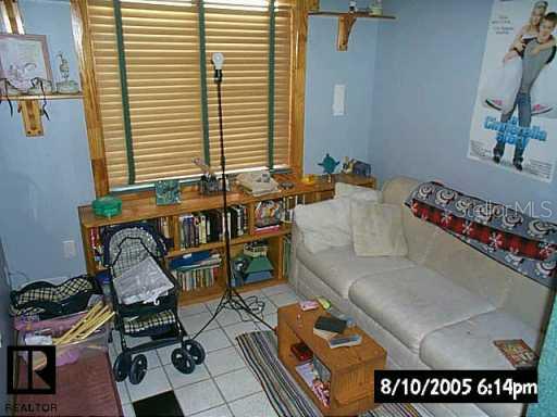 7413 Mitchell Ranch Road New Port Richey, FL 34655 - Photo 9 of 9 a living room with furniture and floor to ceiling window