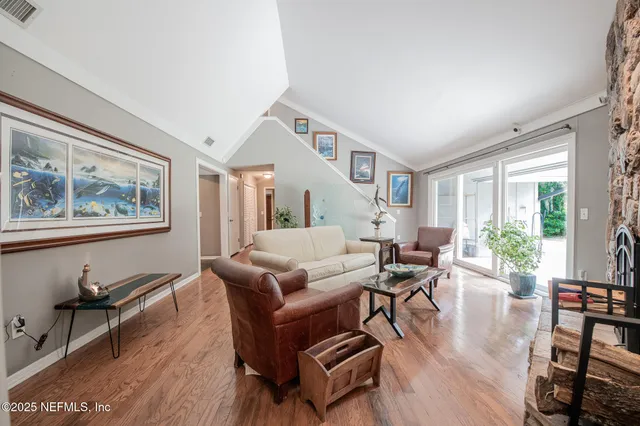 a kitchen with stainless steel appliances granite countertop a refrigerator a stove a sink and a oven