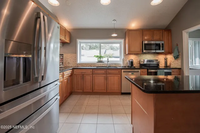 a spacious bedroom with a bed and a large window