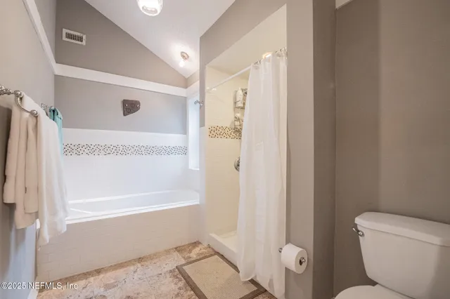 a view of staircase with lots of frames on wall and a window