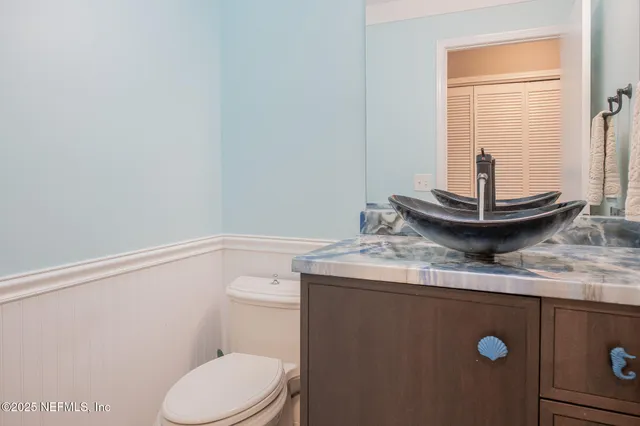 a backyard of a house with plants and large trees