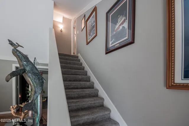 a view of ocean with boats and trees around