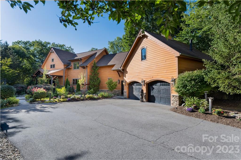 649 Morgan Hill Road Fairview, NC 28730 - Photo 2 of 48 a view of a house with garden and garage