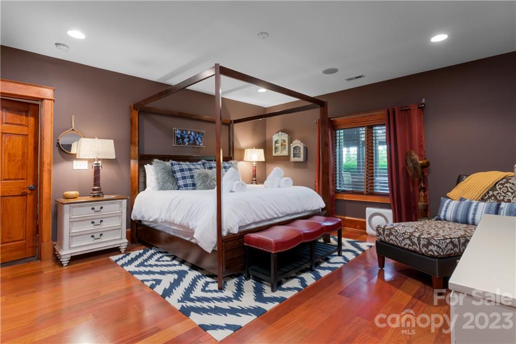 649 Morgan Hill Road Fairview, NC 28730 - Photo 27 of 48 a bedroom with furniture and a bed