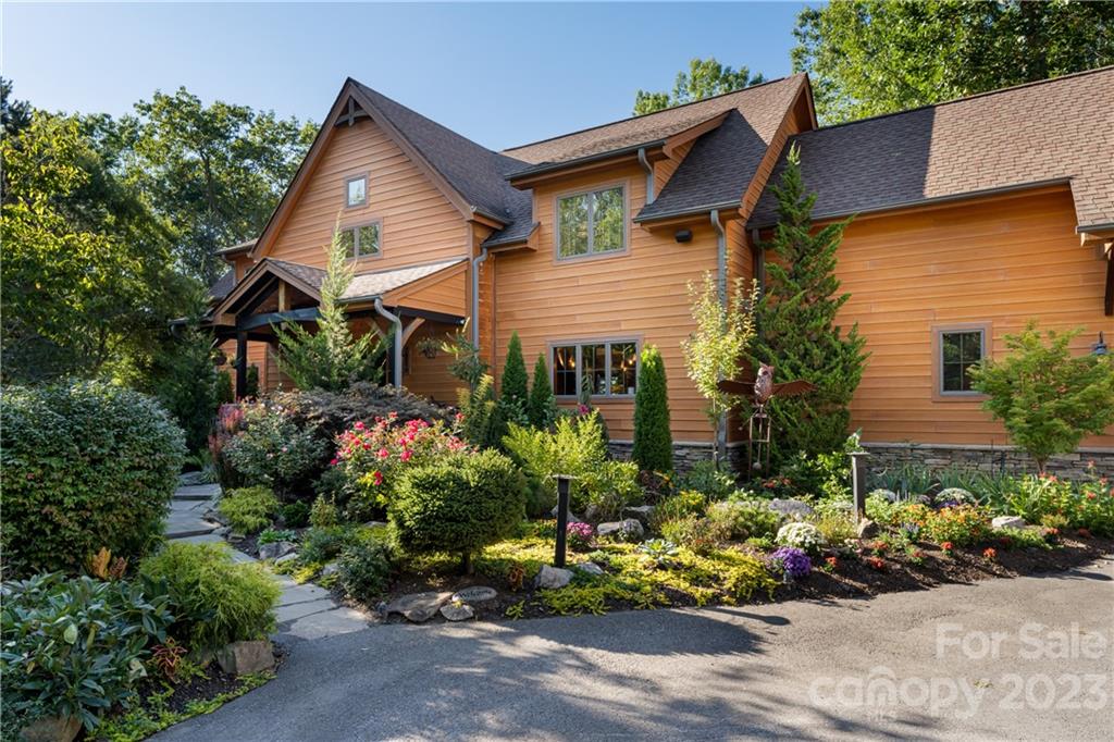 649 Morgan Hill Road Fairview, NC 28730 - Photo 3 of 48 a view of a house with a lot of flower plants