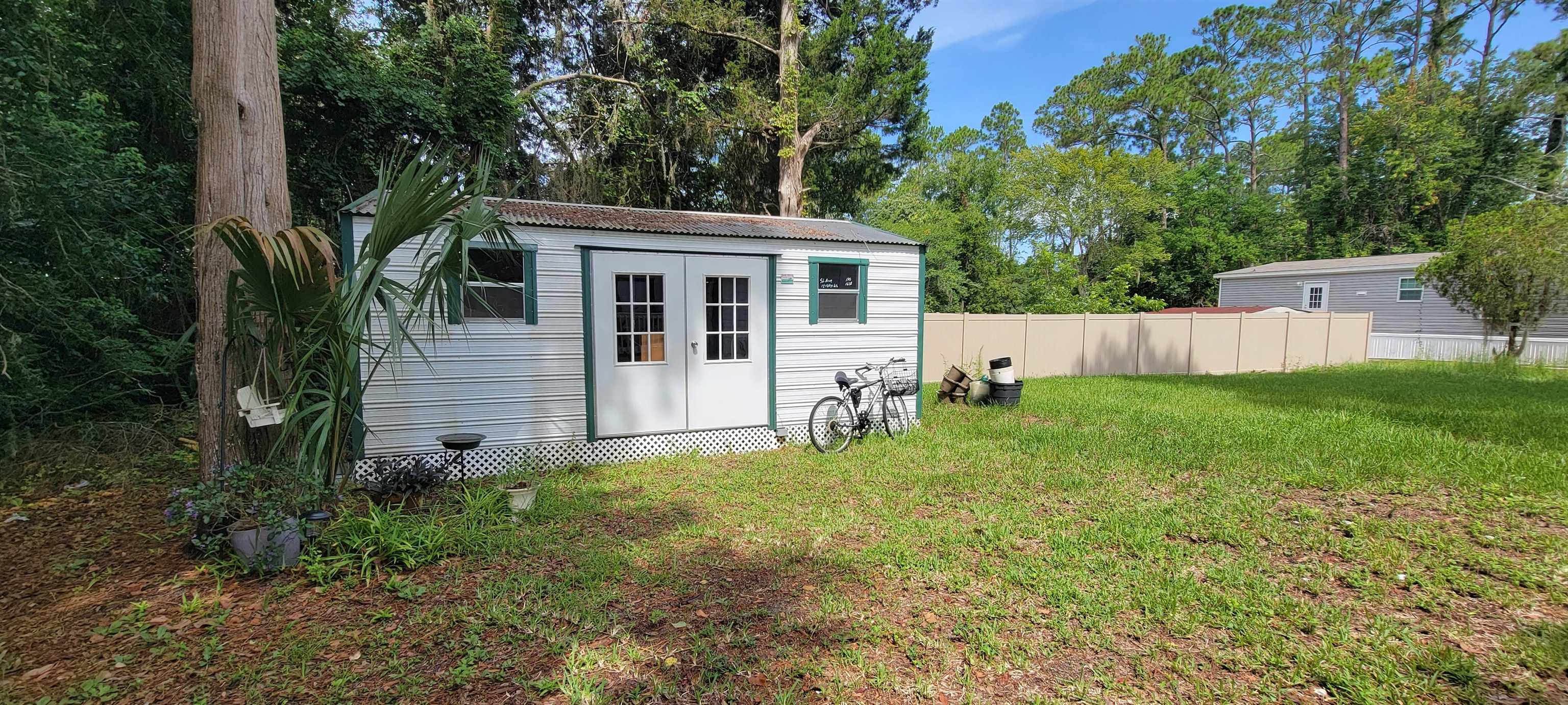 1295 Woodlawn Road St. Augustine, FL 32084 - Photo 15 of 19 a view of a house with backyard and a tree