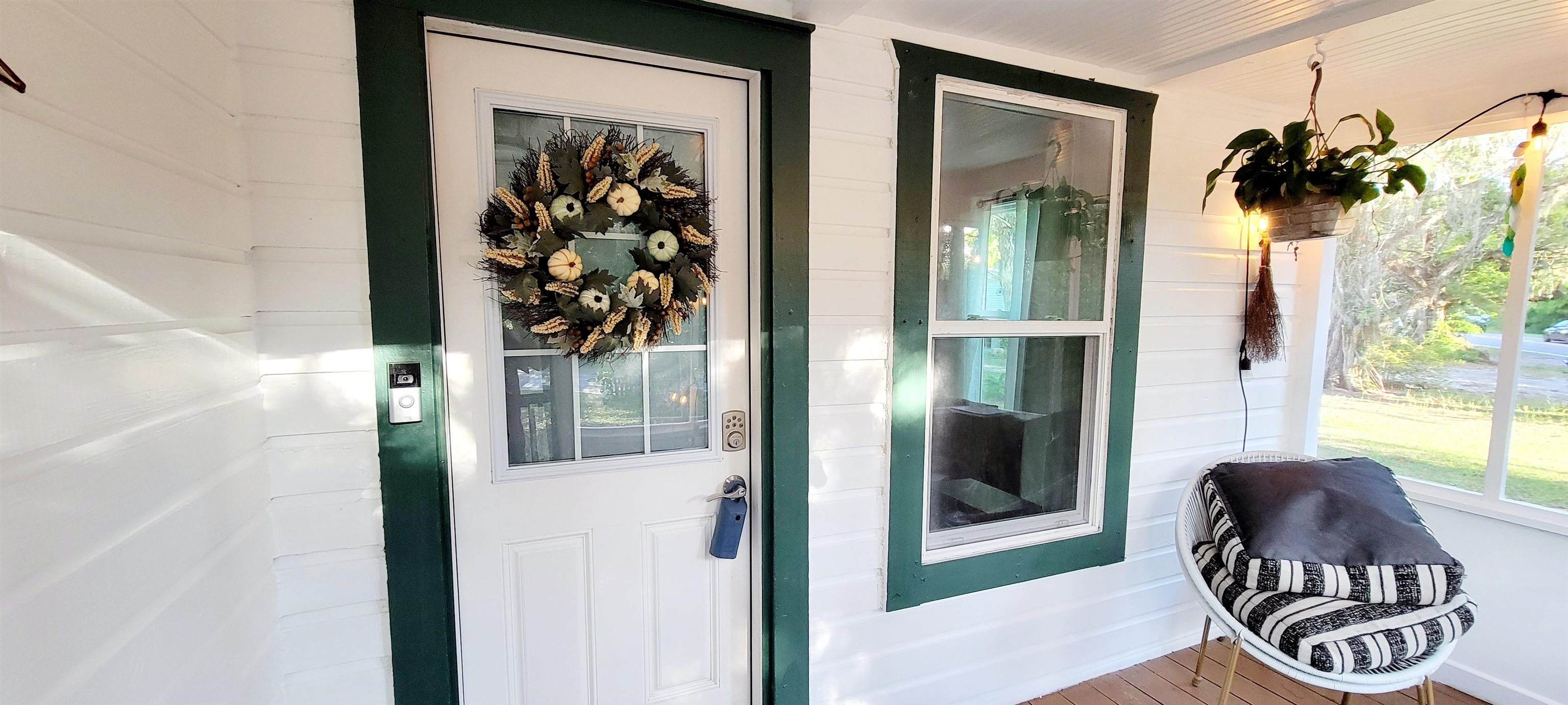 1295 Woodlawn Road St. Augustine, FL 32084 - Photo 3 of 19 a front view of a house with a potted plant and a window