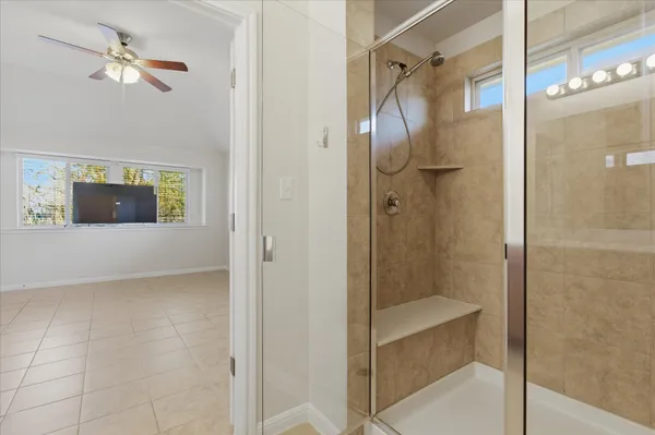 a bathroom with a shower and a mirror