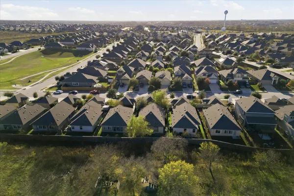 an aerial view of residential houses with outdoor space and river