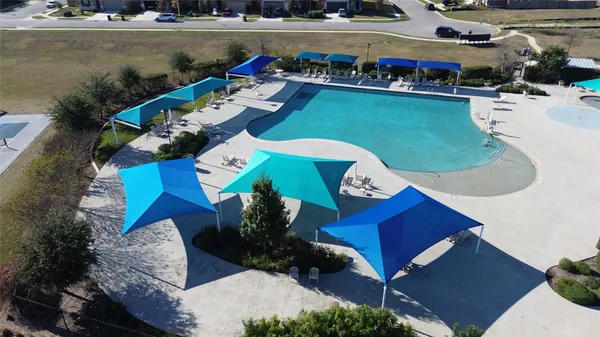 an aerial view of a house with swimming pool and outdoor seating