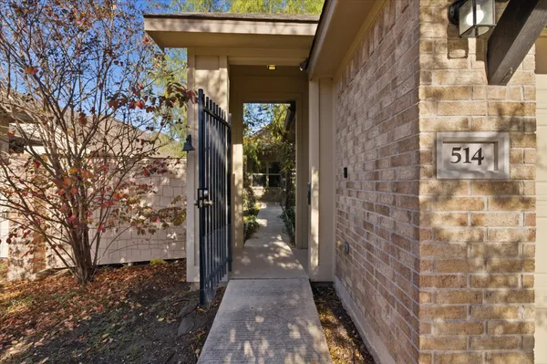 a view of a brick house with a tree