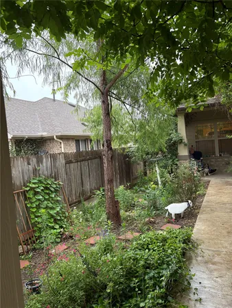 a view of a chair and tables in the back yard of the house