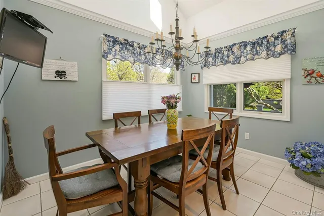 a view of a dining room with furniture and chandelier