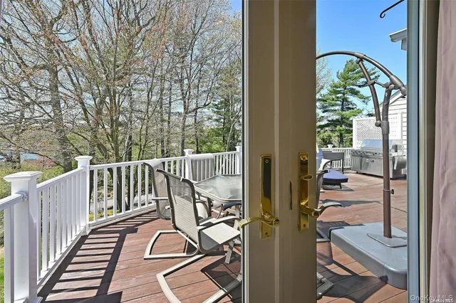 a view of balcony with wooden floor and windows