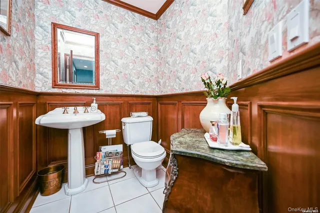 a bathroom with a sink a toilet and a mirror