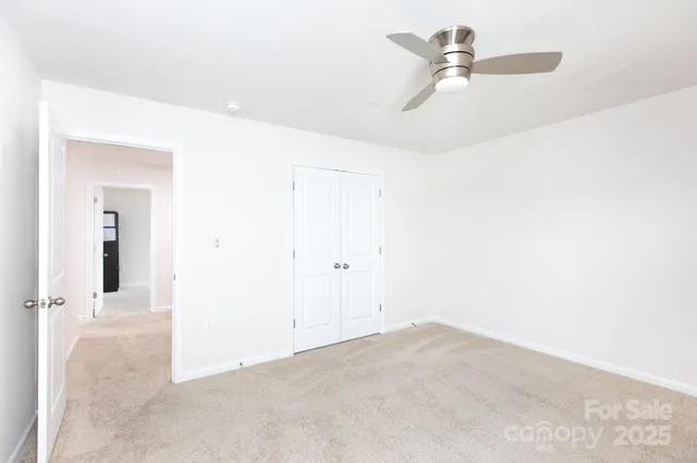 a view of a room with a ceiling fan