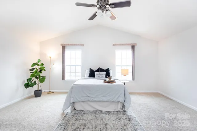 a bedroom with a bed and ceiling fan
