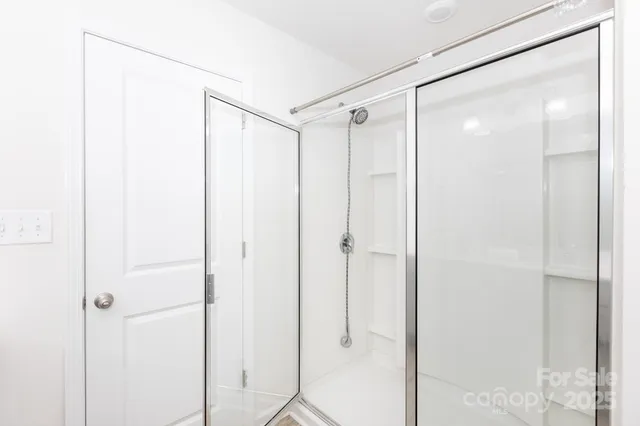 a bathroom with a shower and a glass door
