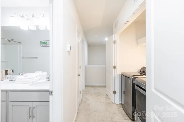 a bathroom with a sink a washer and dryer
