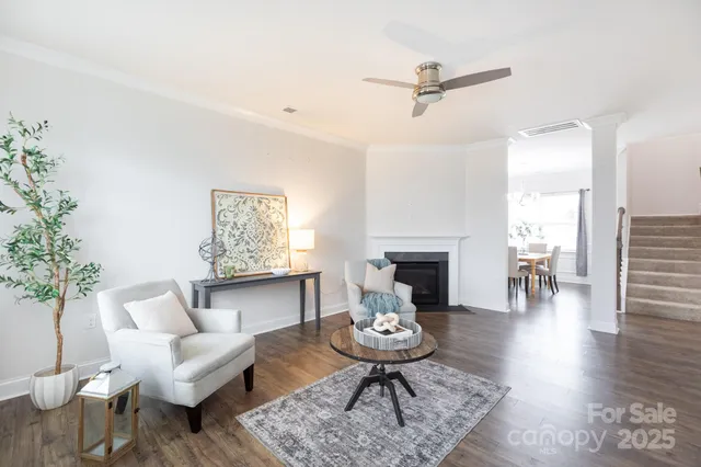 a living room with furniture a table and a fireplace
