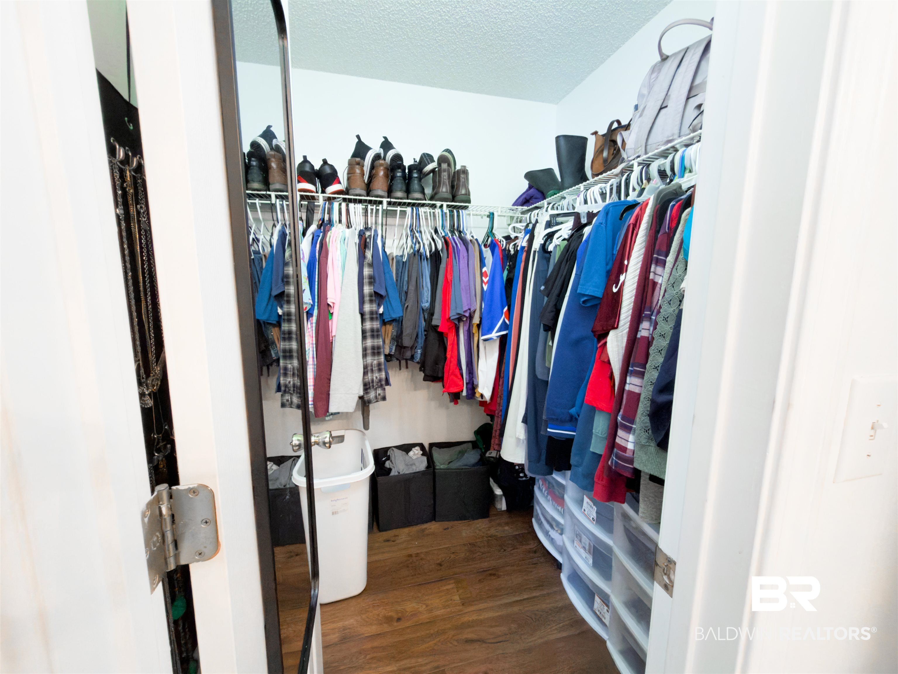 129 Pennbrooke Loop Foley, AL 36535 - Photo 28 of 44 Walk in closet with dark wood-type flooring