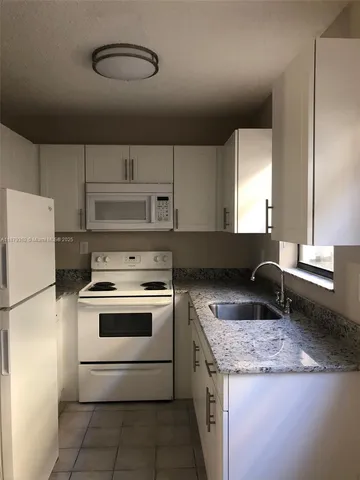 a kitchen with a stove and a sink