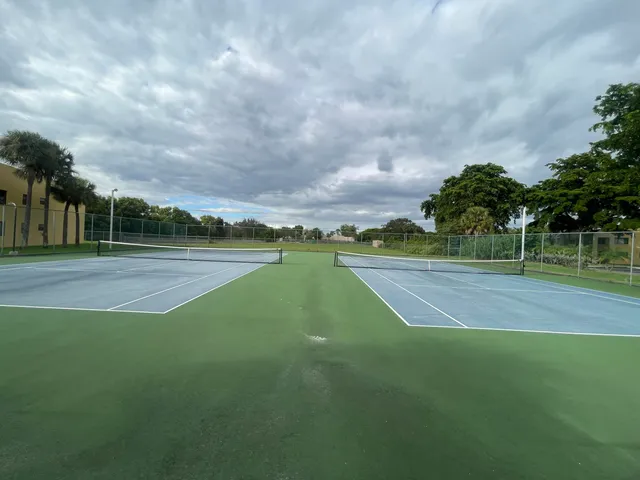 a view of a playground and basketball court