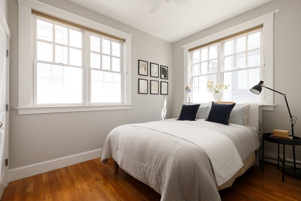 80 Webster Avenue, Unit 2A Somerville, MA 02143 - Photo 13 of 19 a bedroom with a bed and wooden floor