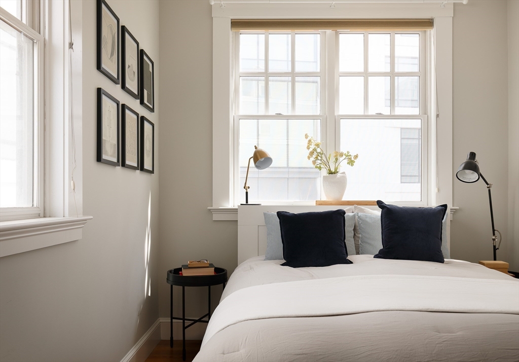 80 Webster Avenue, Unit 2A Somerville, MA 02143 - Photo 14 of 19 a bedroom with a bed and wooden floor
