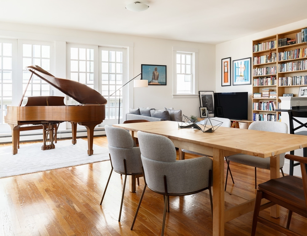 80 Webster Avenue, Unit 2A Somerville, MA 02143 - Photo 8 of 19 a dining room with furniture and wooden floor