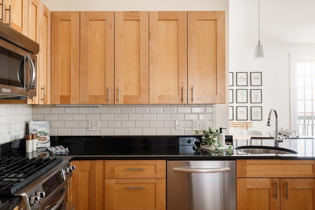 80 Webster Avenue, Unit 2A Somerville, MA 02143 - Photo 9 of 19 a kitchen with stainless steel appliances a sink stove and cabinets