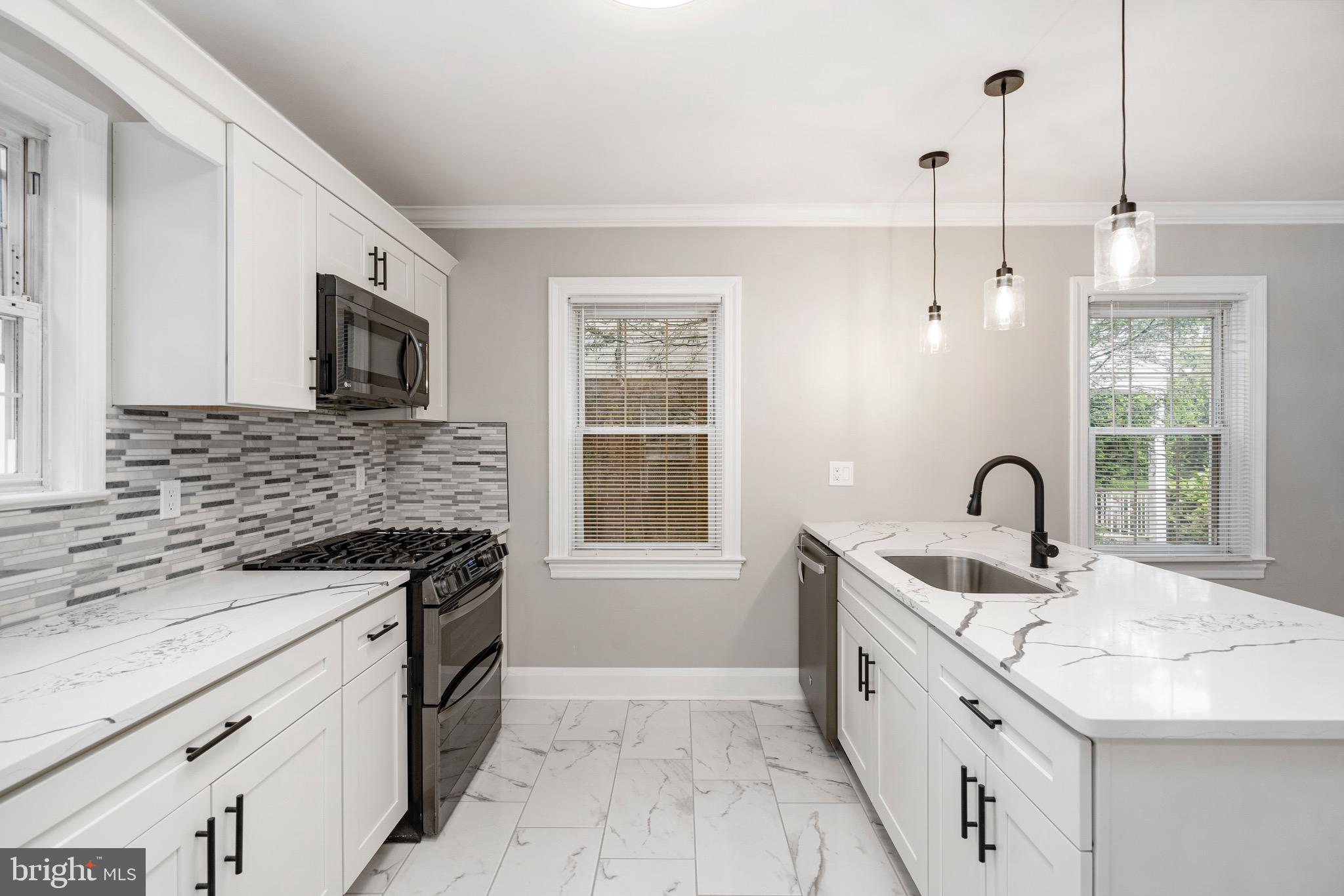 5311 Herring Run Drive Baltimore, MD 21214 - Photo 11 of 43 a kitchen with granite countertop a sink stainless steel appliances and a counter space