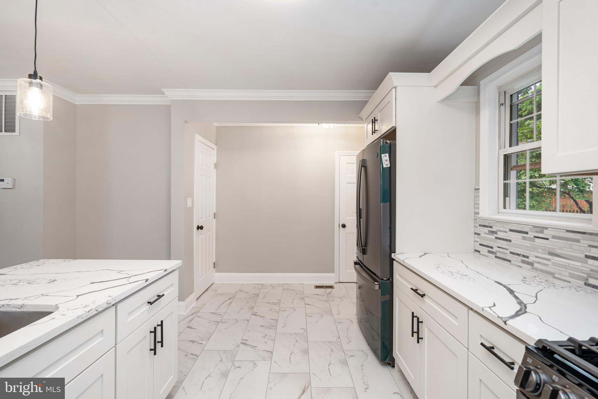 5311 Herring Run Drive Baltimore, MD 21214 - Photo 13 of 43 a spacious bathroom with a granite countertop sink a mirror and a shower