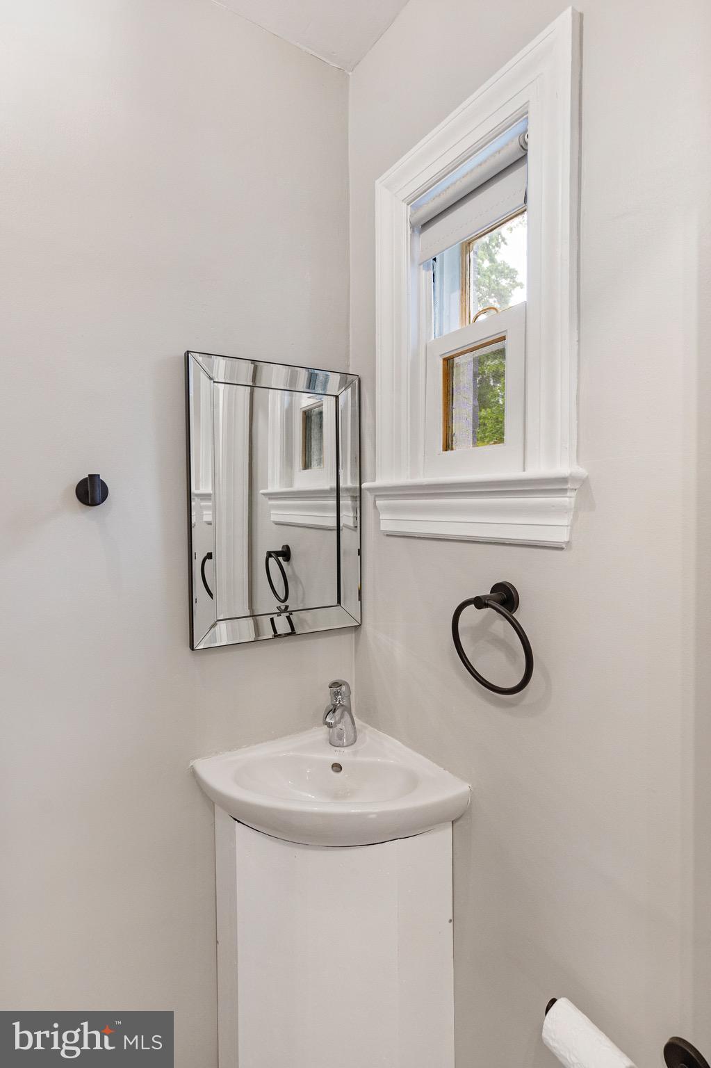 5311 Herring Run Drive Baltimore, MD 21214 - Photo 16 of 43 a bathroom with a sink and a mirror
