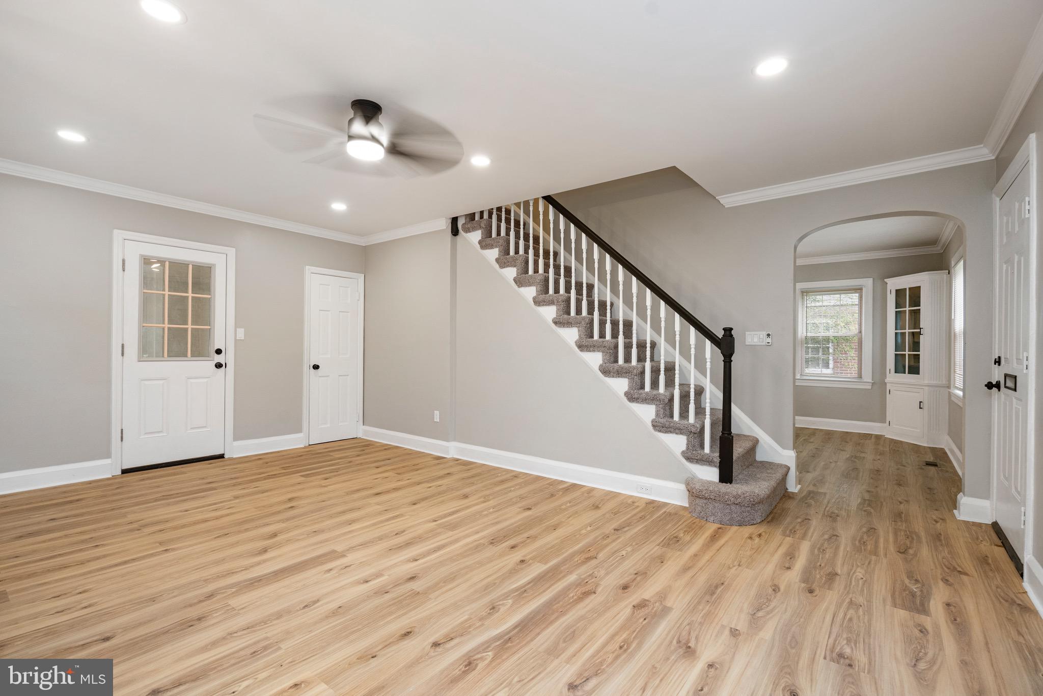 5311 Herring Run Drive Baltimore, MD 21214 - Photo 19 of 43 a view of an empty room with wooden floor and a ceiling fan