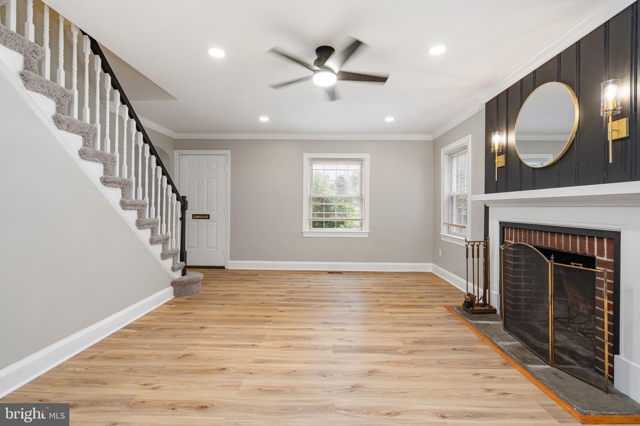 5311 Herring Run Drive Baltimore, MD 21214 - Photo 20 of 43 a view of an empty room with wooden floor a fireplace and a window