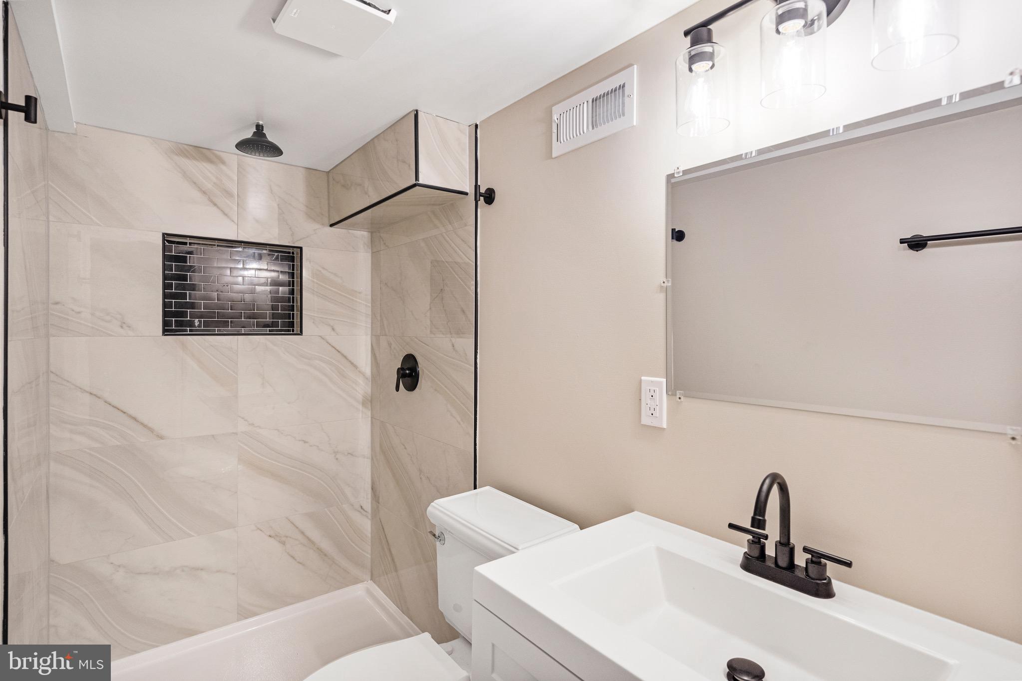 5311 Herring Run Drive Baltimore, MD 21214 - Photo 23 of 43 a bathroom with a sink toilet and shower