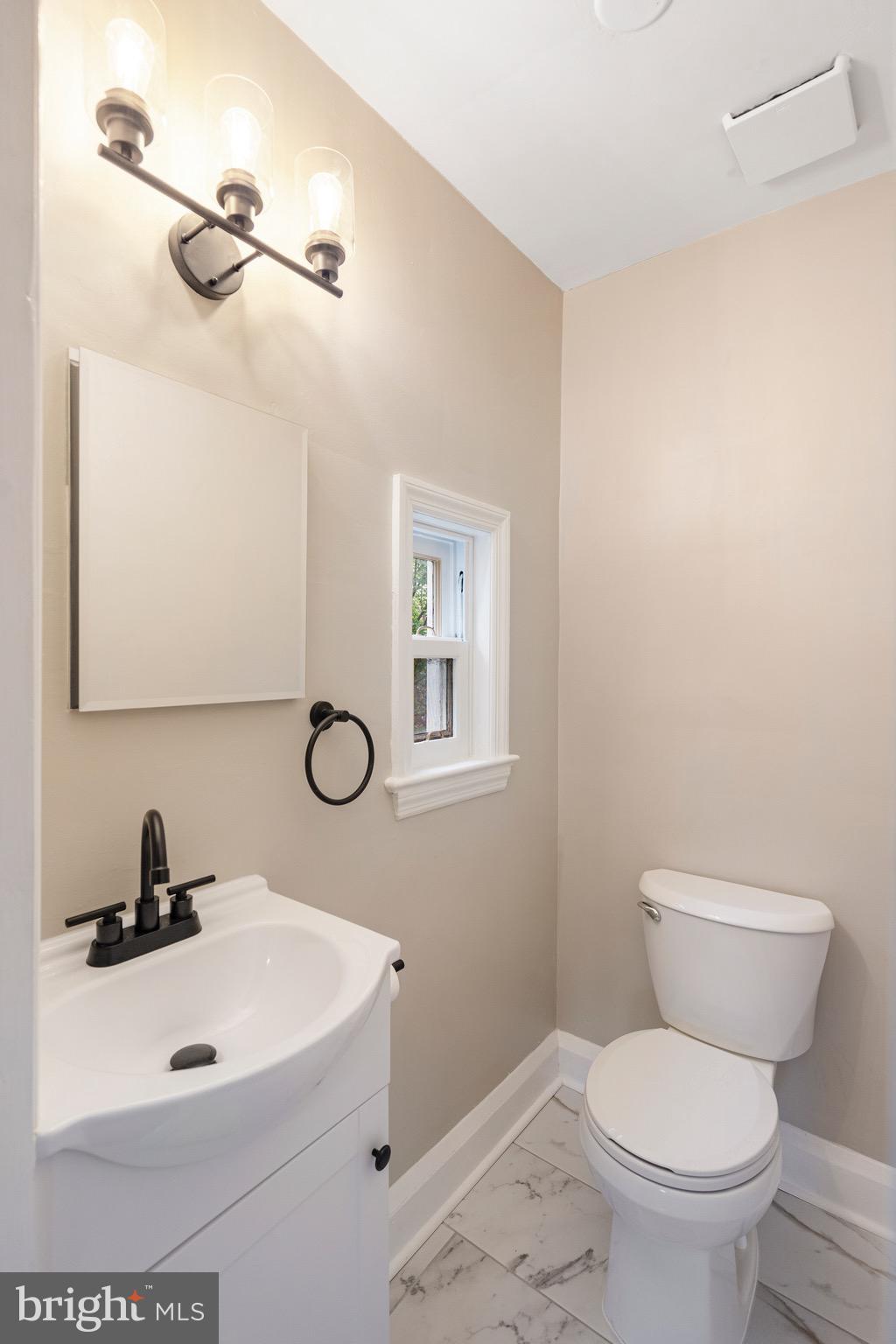 5311 Herring Run Drive Baltimore, MD 21214 - Photo 29 of 43 a bathroom with a sink a toilet and a mirror