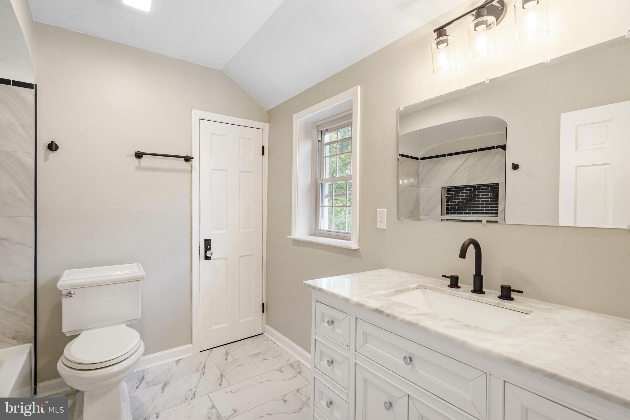 5311 Herring Run Drive Baltimore, MD 21214 - Photo 34 of 43 a bathroom with a sink a toilet and a mirror