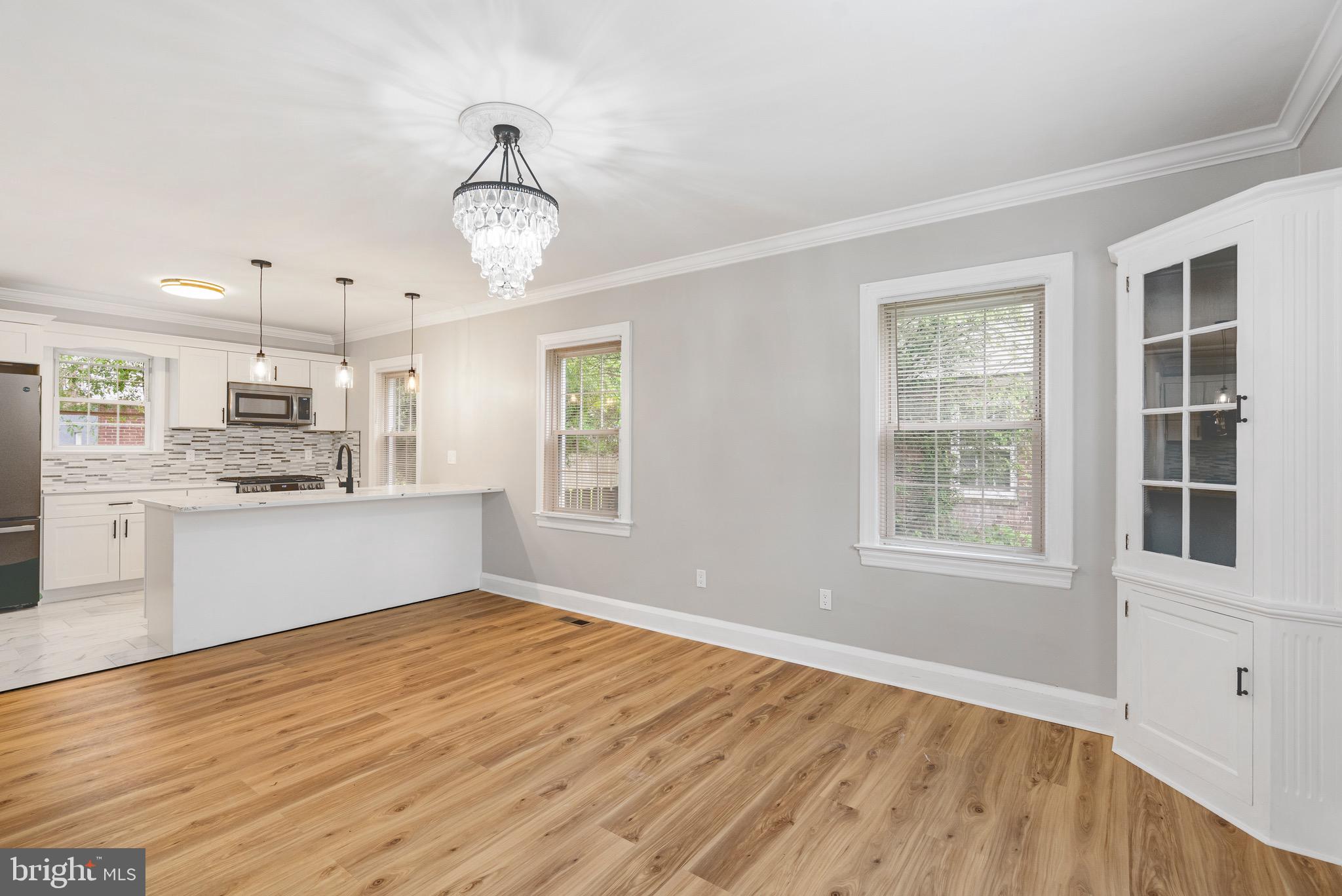 5311 Herring Run Drive Baltimore, MD 21214 - Photo 4 of 43 a view of a kitchen with wooden floor and windows