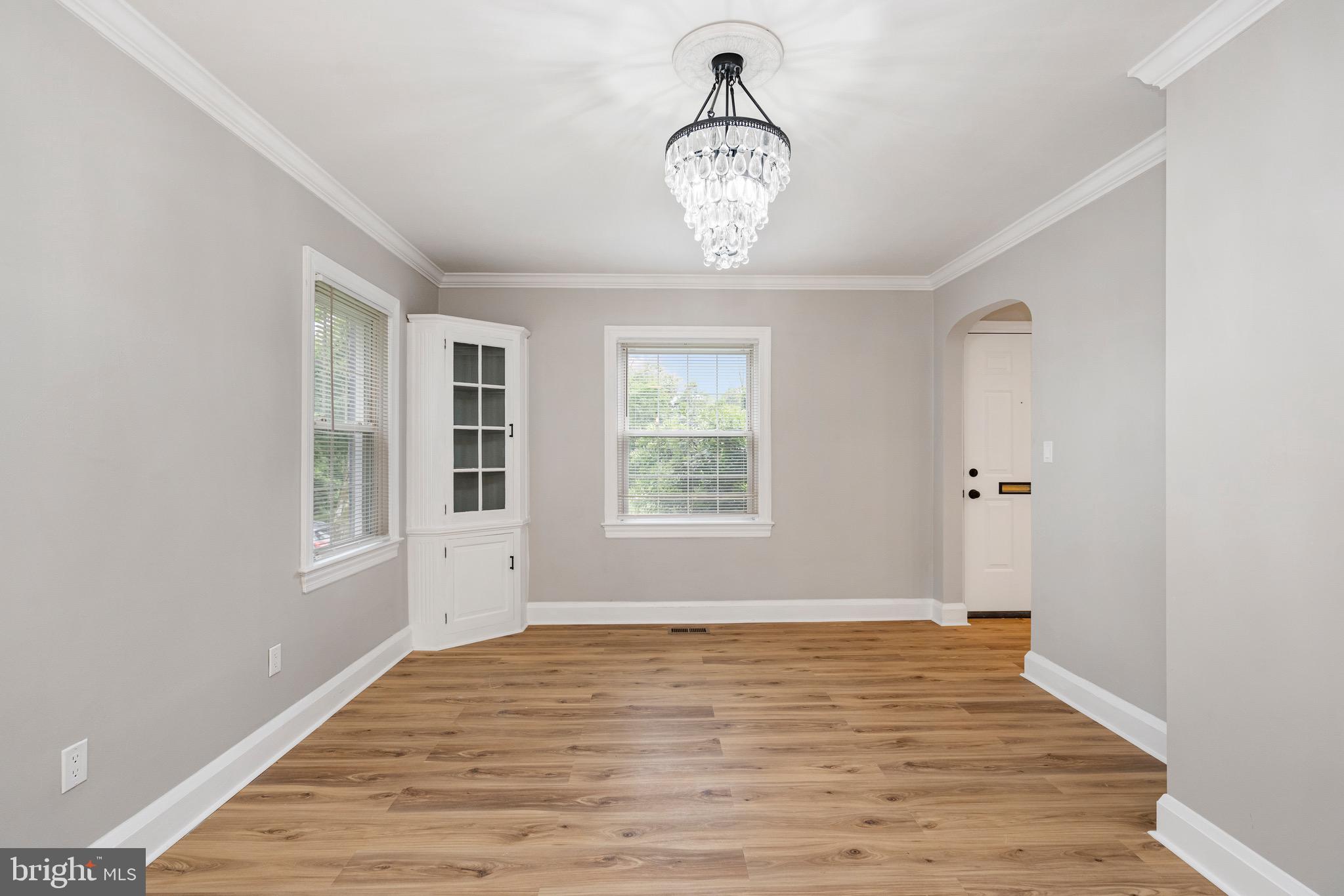 5311 Herring Run Drive Baltimore, MD 21214 - Photo 7 of 43 a view of an empty room with wooden floor and a window